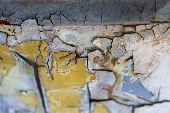 Selective focus on cracked and peeling paint surfaces on old cars. The background image looks old. vintage and classic