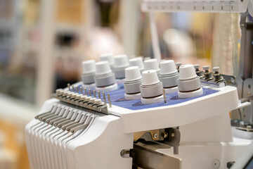Threads on a sewing machine in loops from spools during automatic operation.