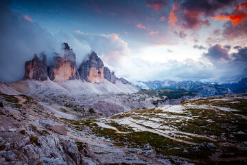 Tre Cime di Lavaredo (Drei Zinnen) under a dramatic sky. Sexten Dolomiti, South Tyrol, Europe. - obrazy, fototapety, plakaty