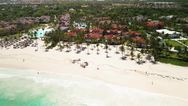 Tropical resort, coastline and condos on paradise island landscape. Beautiful Caribbean palm beach with palms and white sand. Hotel on the shores of the Caribbean Sea. Travel to the Dominican Republic