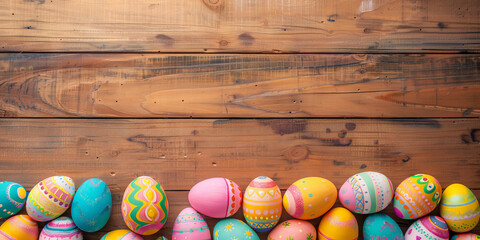 Naklejka na ściany i meble colorful painted easter eggs on wood background. Easter frame of eggs painted in blue red yellow pink green colorful color. Flat lay, top view. Copy space for text