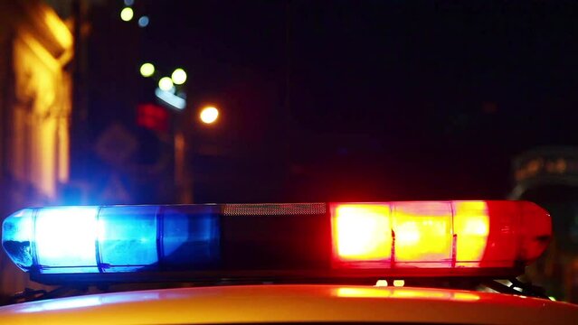 Police car with siren lights on.

