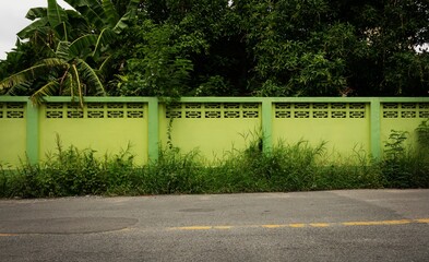 A green fence with a green wall