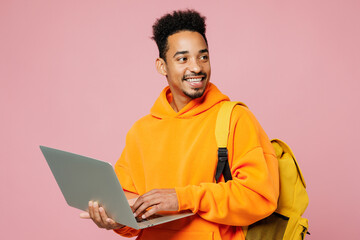 Young student IT man of African American ethnicity yellow hoody casual clothes backpack bag hold...