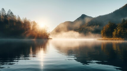 Lake in the early morning fog with sun and mountain view