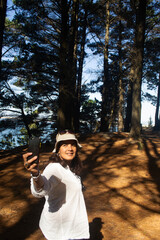 a woman taking a selfie photo in a forest in southern Chile