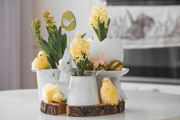 Happy Easter. Spring yellow hyacinth flowers in an egg-shaped vase, chicken chicks on a white...