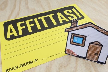 Singola parola AFFITTASI scritta cultura italiana casa in primo piano.