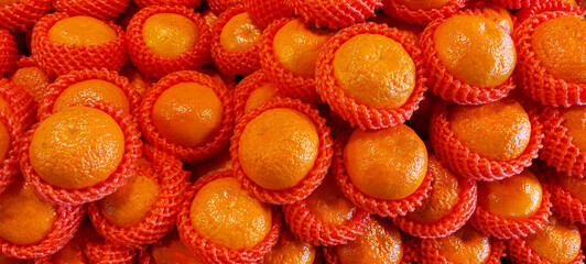 banner of fresh ripe tangerines lying on a market showcase, fruit texture or background