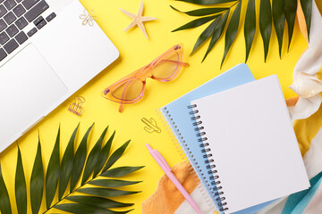 Summer workflow calm. Top-down view of a laptop, notebook, and tropical theme items on a bright yellow background with space for notes - obrazy, fototapety, plakaty