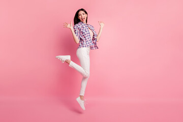 Full length side profile body size photo amazing beautiful her she lady jump high party holiday wear shoes casual checkered plaid shirt white jeans denim clothes outfit isolated pink background