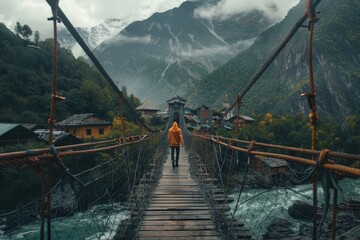 A person walking across a suspension bridge over a river. Suitable for travel or adventure concepts