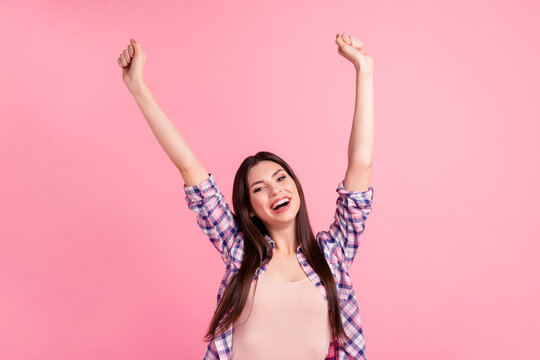 Close up photo yelling amazing beautiful her she lady amusement both arms hands raised up party festive celebrate holiday wear casual checkered plaid shirt clothes outfit isolated pink background