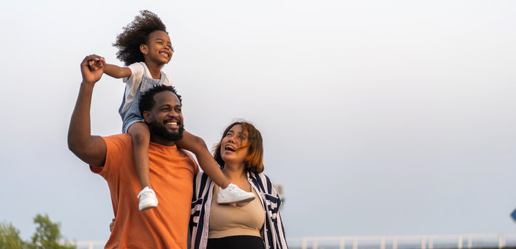Portrait of enjoy happy love black family.play, having fun, daughter, parenthood, care, superhero.african american father and mother with little african girl child smiling moments good time at home
