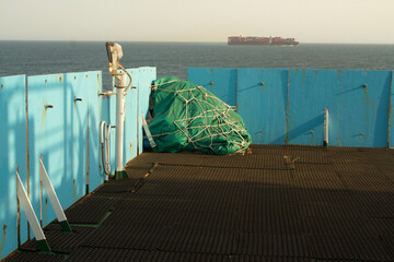 View of the vessel hardening metal plates on the bridge wing of a ship at sea