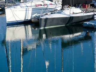 Boats and boats water reflexion in water. Abstract distorted boat elements in water. Blue water...