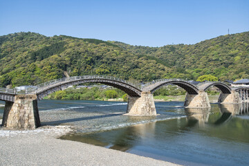Iwakuni at Kintaikyo Bridge over the Nishiki River on a sunny day (Hiroshima, Japan)