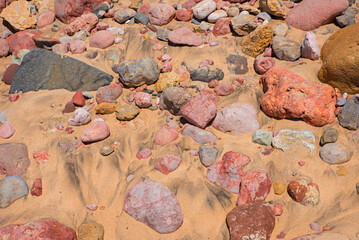 colorful sandstone gravels in the sandy ground