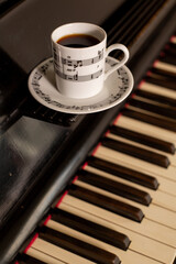 The white coffee cup put on vintage piano key - 760638928