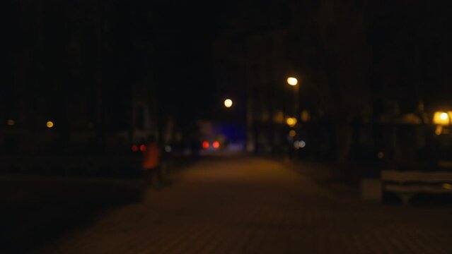 Defocused: Emergency lights at night in a small city