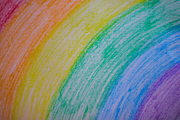 a rainbow made with chalk on paper with some crayons
