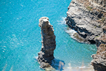 greece andros island beach called tis grias to pidima, rock high in the sea