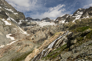 Fototapeta na wymiar Waterfall valley and alpine glacier