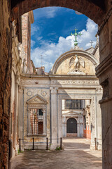 Campo San Giovanni (St John Square) in Venice, with renaissance marble screen erected in 1481, seen from narrow lane - 760692792