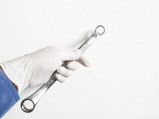 Man's hand with gloves holds a spanners isolated on white background. Mechanical tools concept.