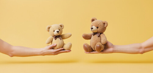 Two hands touching or holding from different sides plush toy to represent parental care and custody - obrazy, fototapety, plakaty