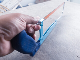 The hand adjusting the screw adjuster Pipe saw for plumbing work tools.