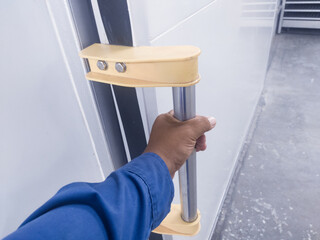 The hand hold the handle sliding door in corridor room for open or closed. The concept for modern sliding door fungtion.