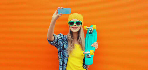Summer portrait of happy smiling blonde young woman taking selfie with smartphone and skateboard - Powered by Adobe