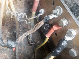 Burnt ground cable, failure in the industrial electrical installation grounding system. Failure earth system concept.