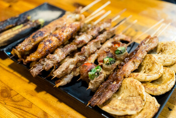 Variety of meat skewers on dish