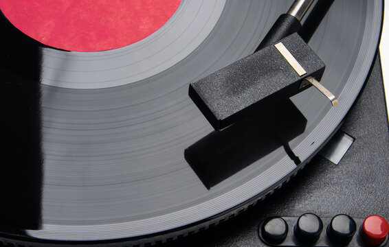 close-up of a turntable with buttons for vinyl records, music
