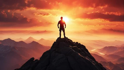 Poster Beautiful shot of a person standing on top of a mountain looking at sunset © Natallia