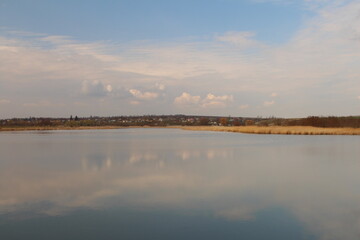 A body of water with clouds in the sky