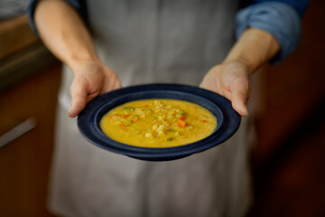 Photograph of a chef presenting a delicious hearty Vegetable Soup