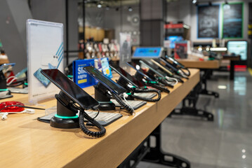 Showcase with smartphones in the modern electronics store. Buy a mobile phone. Many smartphones on...