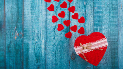 Valentine's day gift. Banner design with present box and hearts on blue wooden background.