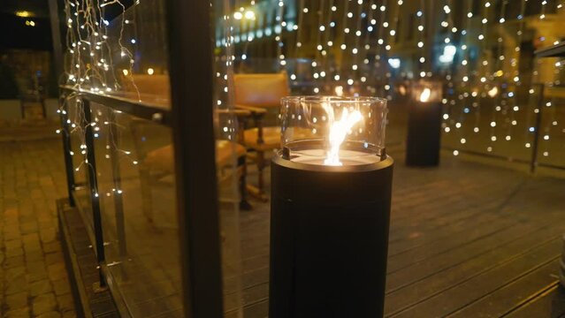 A candle illuminates a room with glass fixtures in the city building