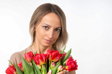 A young, beautiful girl with a large bouquet of luxurious tulips, spring.