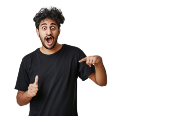 
People and emotions. Indoor photo of young surprised Hindu male standing on left isolated on white background pointing and looking at blank space for your advertisement wearing black t shirt First pe