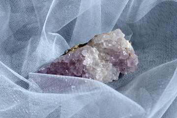 Set of various amethyst natural mineral stones and gemstones on grey paper background