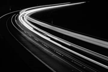 Fotobehang Snelweg bij nacht white lines of car lights on black background