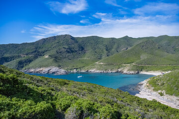 Fototapeta na wymiar Corsica, seascape in the cap Corse, a creek with a boat 