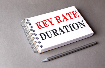 KEY RATE DURATION text on notebook on grey background