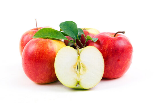 red apples with leaves on a white background