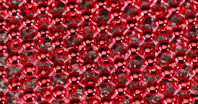 Background  with red and silver shiny pearls rotating in front of a mirror - a really special shiny effect